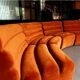 Burnt orange modular sofa for four with a futuristic design.