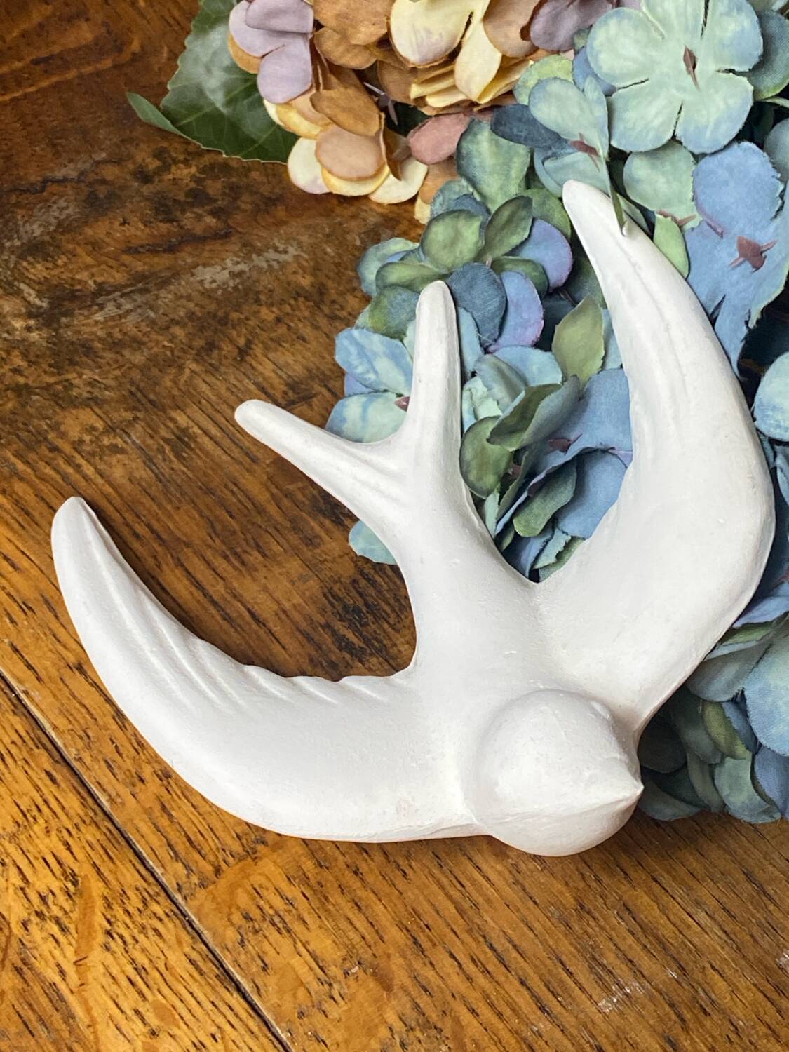 Pair of plaster swallows