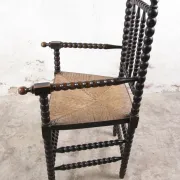 Black bobbin chair with armrests and rush seat – ca. 1900-1930
