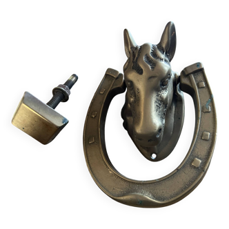 Horse head door knocker on horseshoe