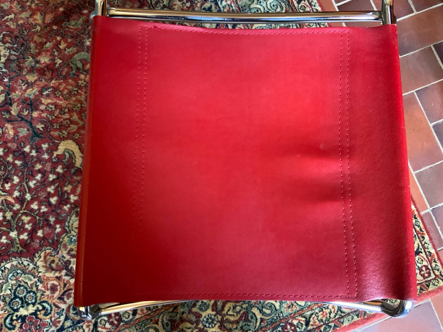 2 tubular chairs in red leather 1970