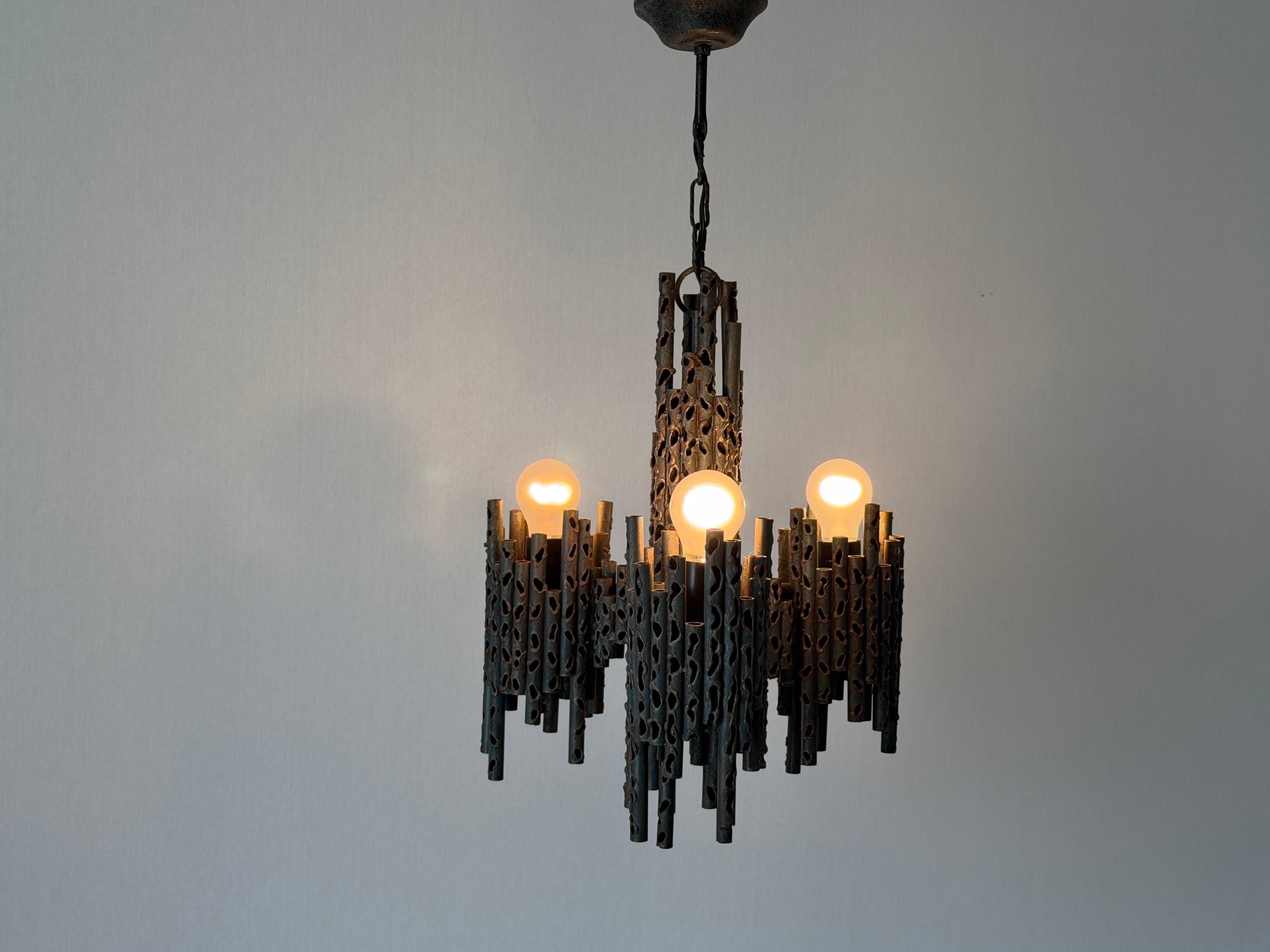 Three-armed suspended lamp in wrought iron, brutalist design, 1960s, Italy.