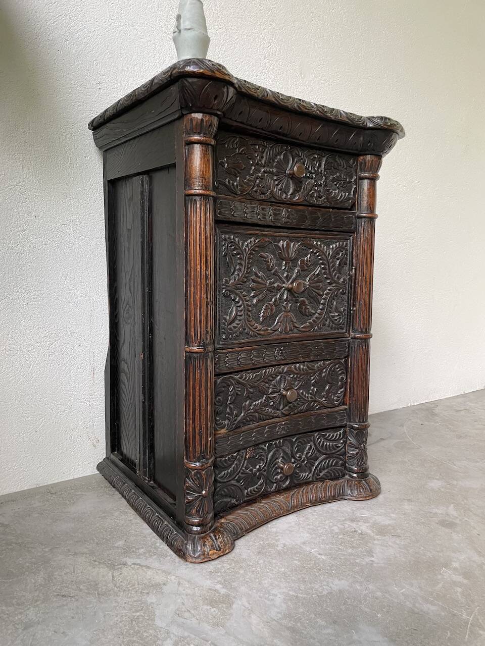 19th century chest of drawers in carved blackened pine