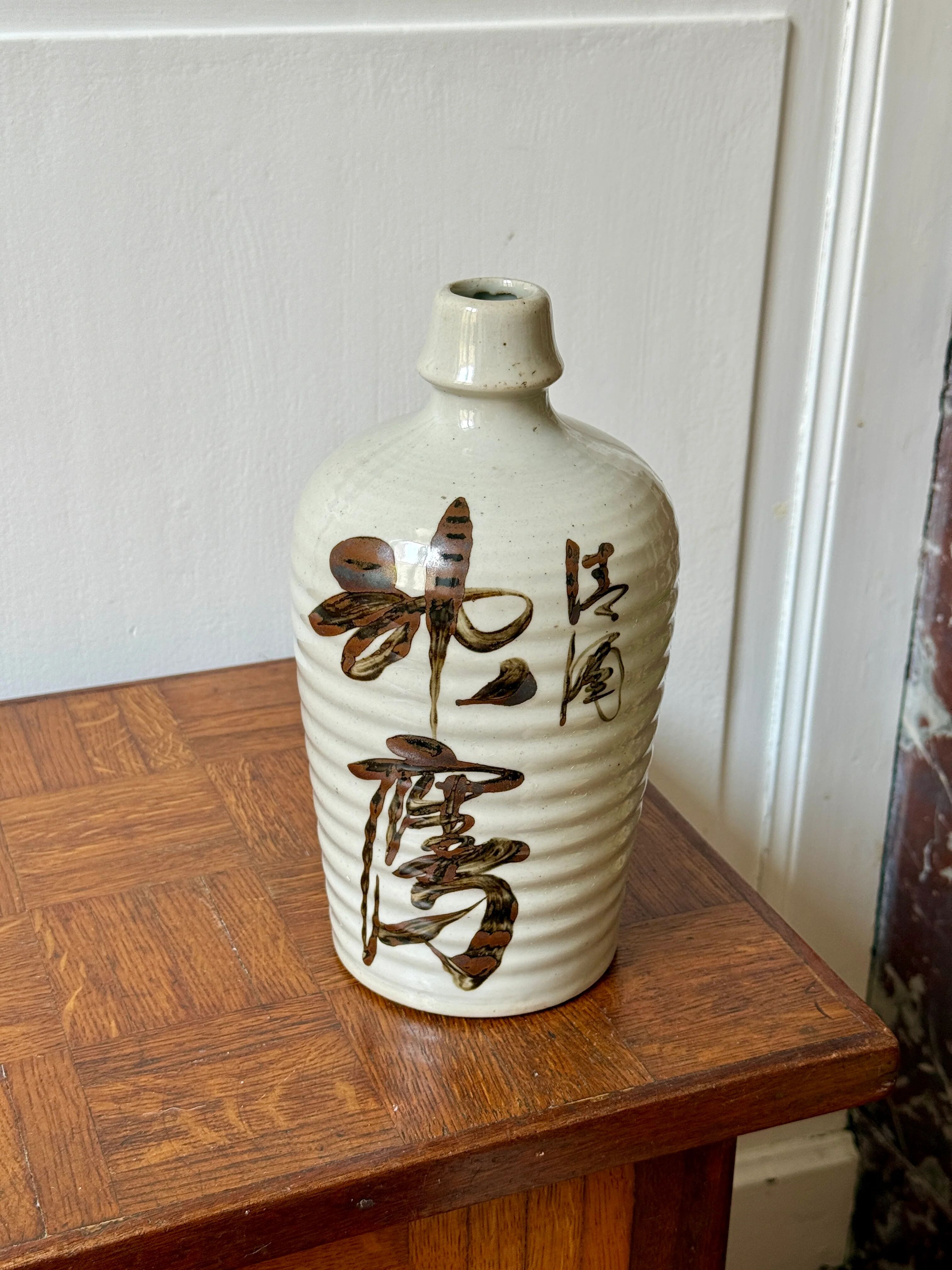 Old Japanese sake bottle in tokkuri shape.