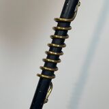 Design floor lamp in black lacquered metal and brass.