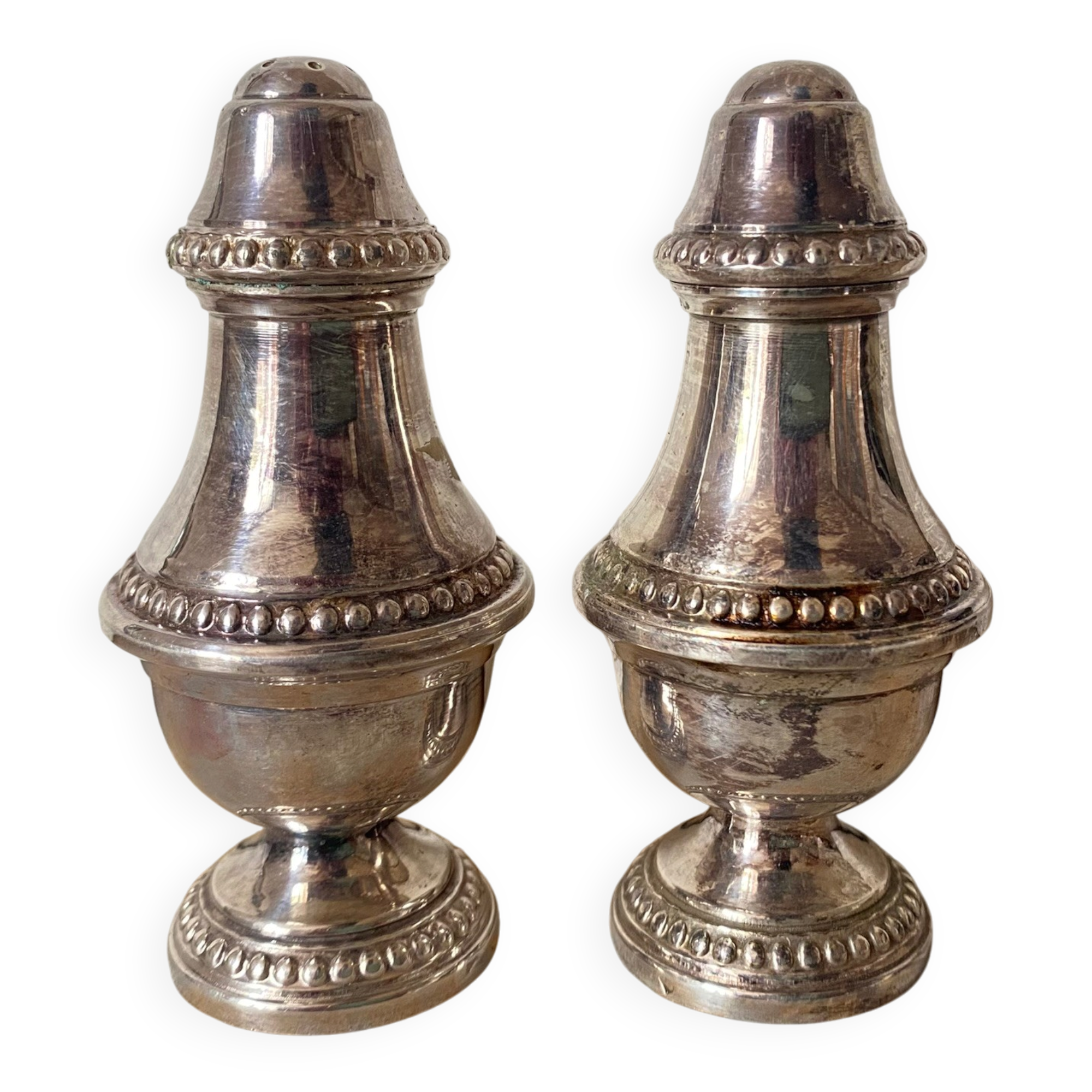 Silver-plated salt and pepper shakers, fluted, beaded decoration.