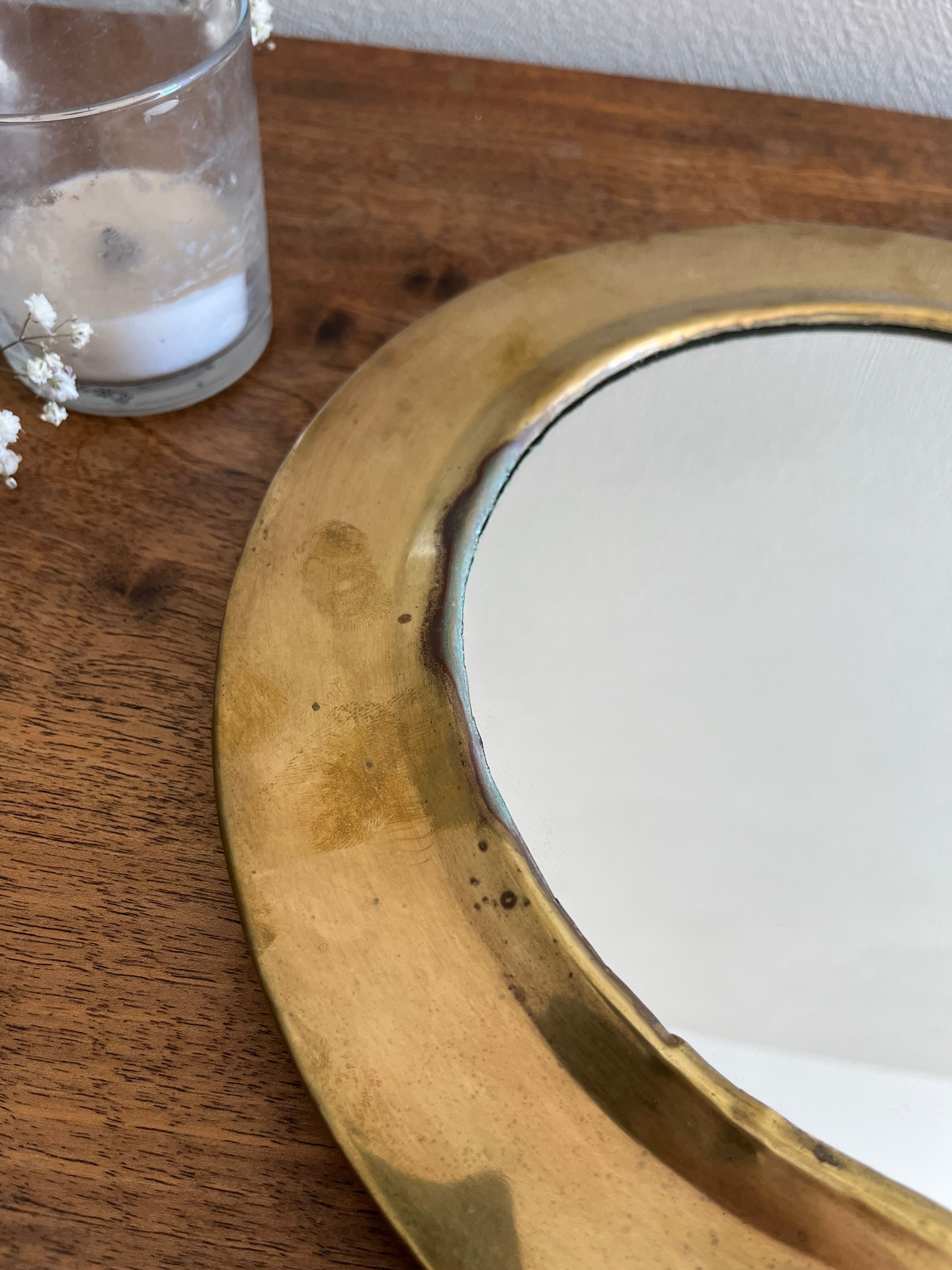 Brass half-moon mirror