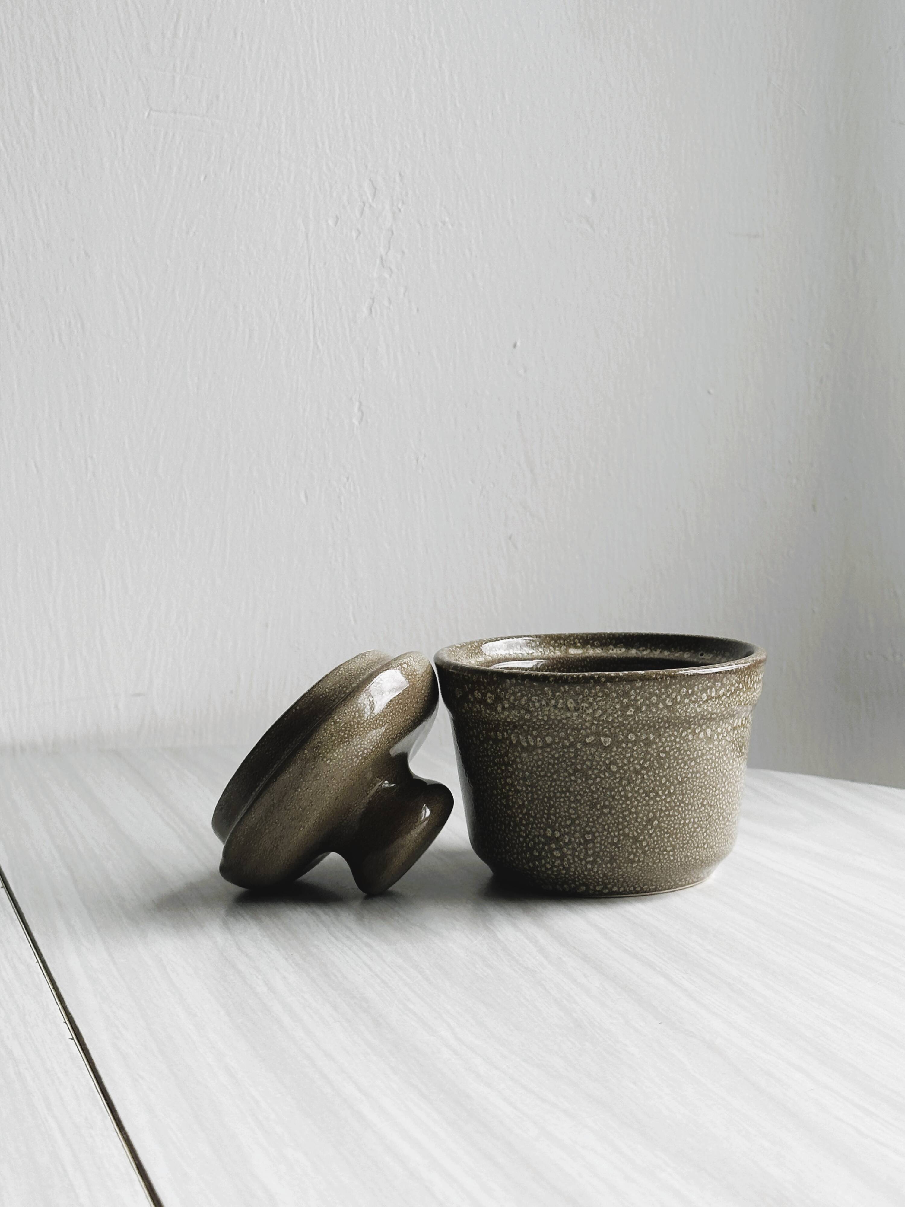 Gray and white speckled ceramic pot.