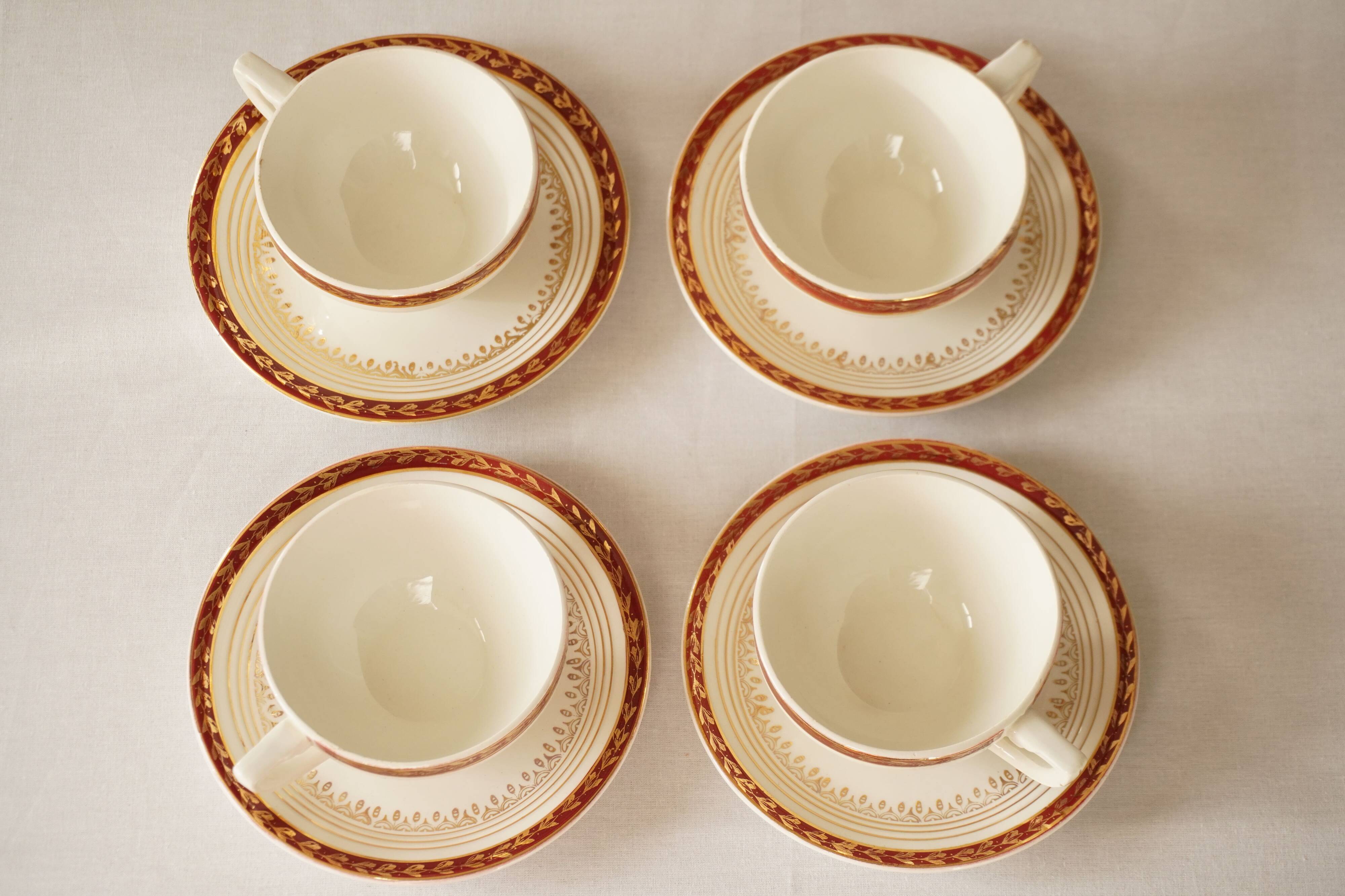 Set of 4 white, red and gold porcelain teacups, Ceranord