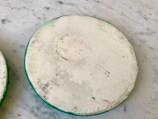Duo of green slip bottle coasters signed marjac bauzil 50s