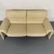 Two-seater designer sofa De Sede DS-2011 in cream leather with adjustable backrest.