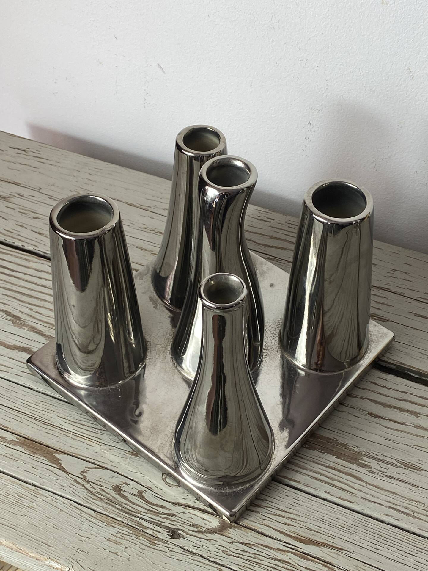 Asymmetrical multitube vase on a base, in silvered ceramic, 1970.