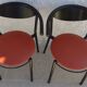 4 gondola-style chairs with a sturdy metal frame and faux leather.