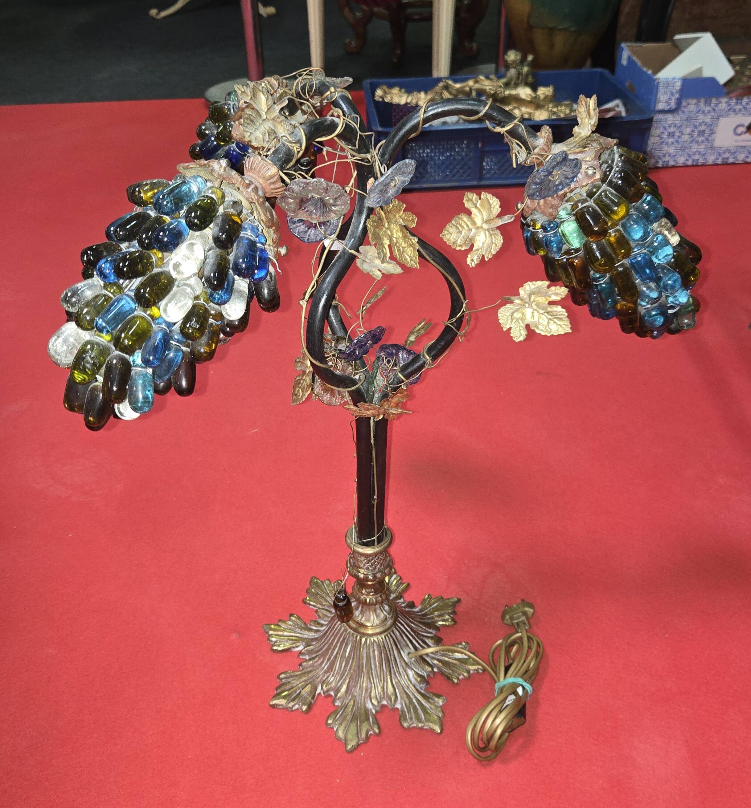 Decorative table lamp in the shape of coloured glass grape clusters.