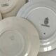 Set of 8 ironstone plates with coordinated designs.