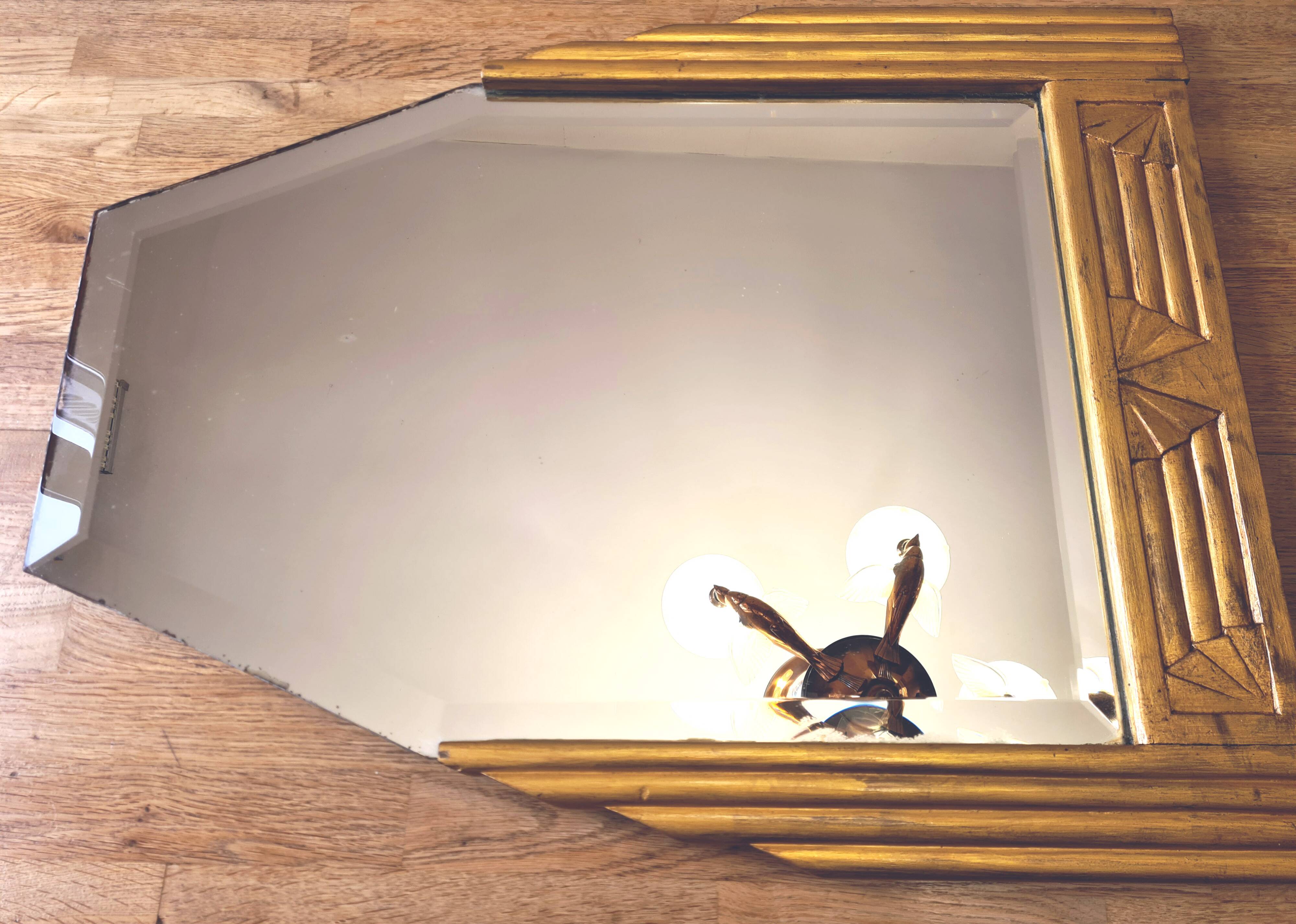 Antique Art Deco mercury mirror, in carved wood with gold leaf.