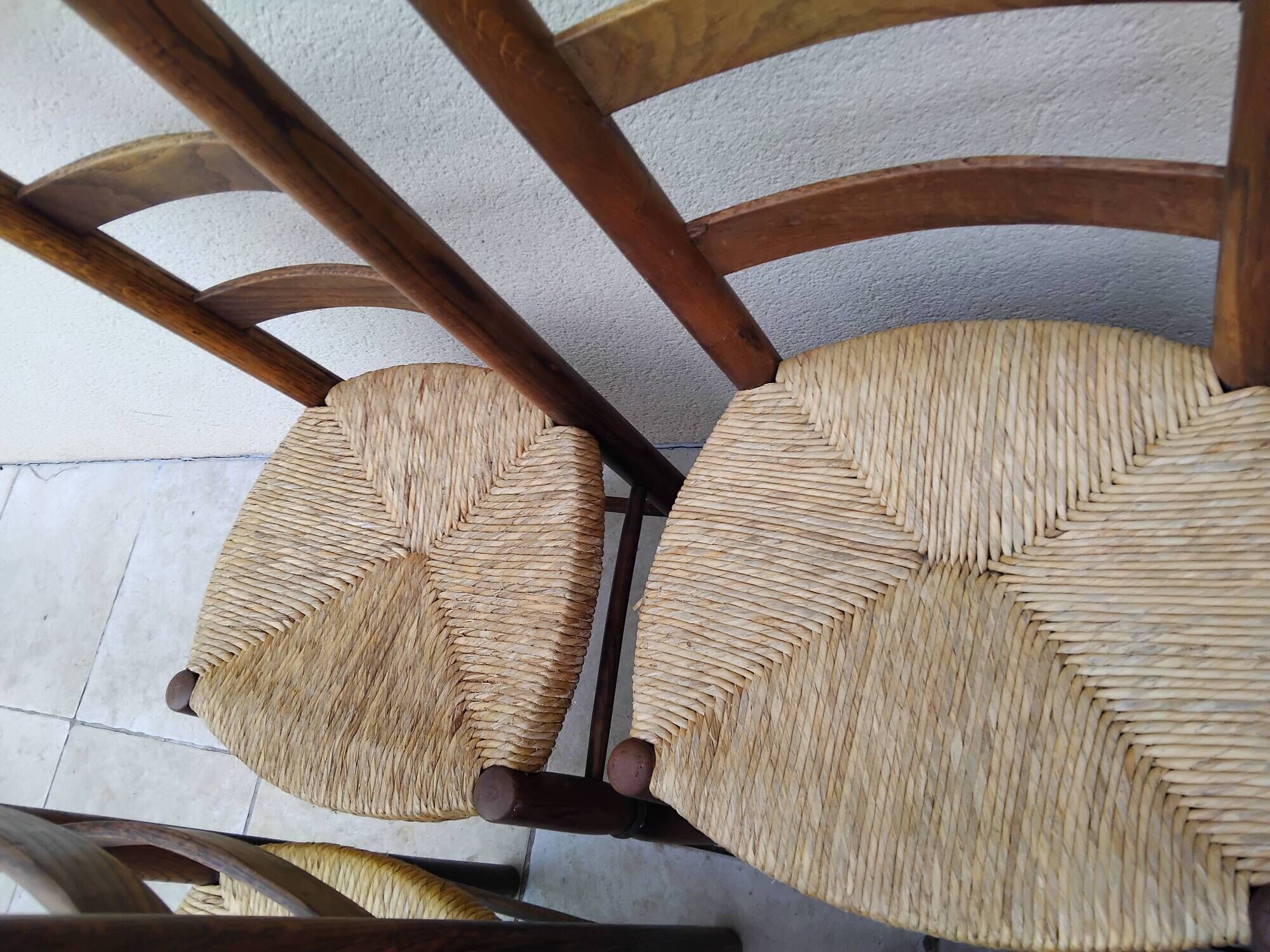 8 vintage straw chairs in the style of Charlotte Perriand.