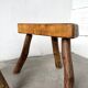 Set of three rustic solid wood tripod stools.