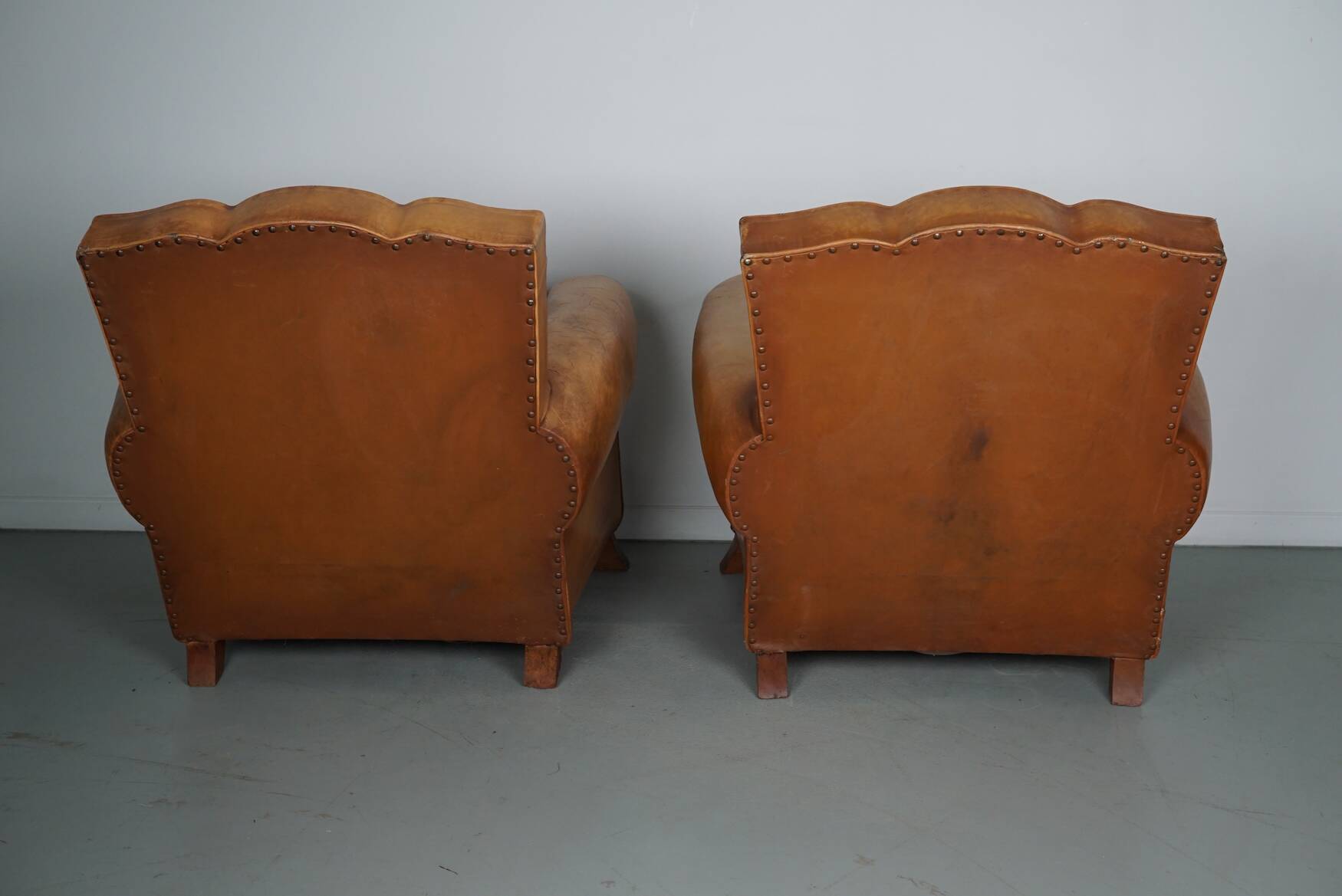 Pair of French Cognac Moustache Back Leather Club Chairs, 1950s