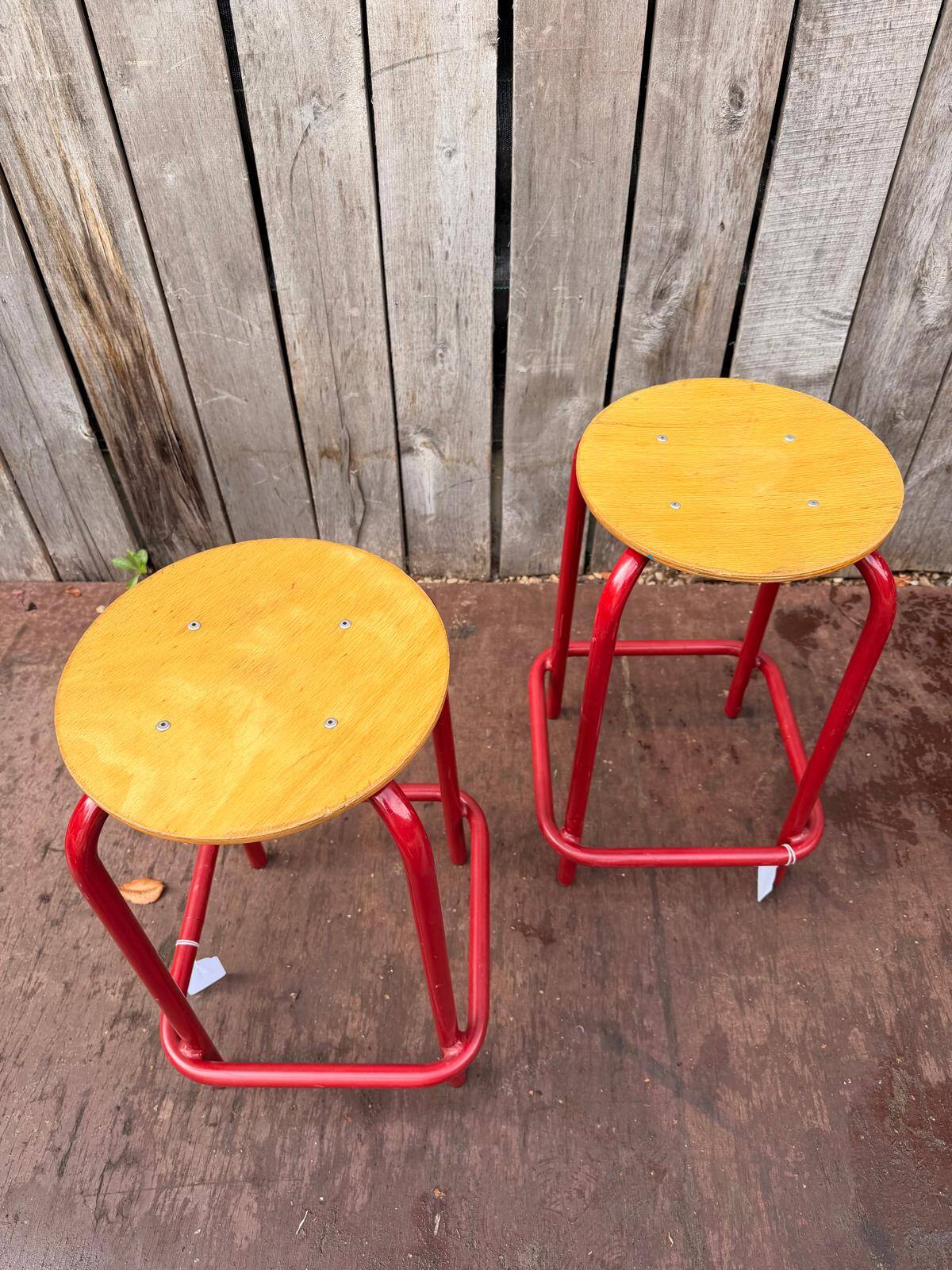 Vintage red industrial stool with a wooden seat, 1960s.