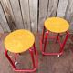 Vintage red industrial stool with a wooden seat, 1960s.