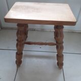 Rectangular wooden stool with 4 turned legs.
