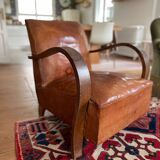 Vintage leather club chair with wooden armrests