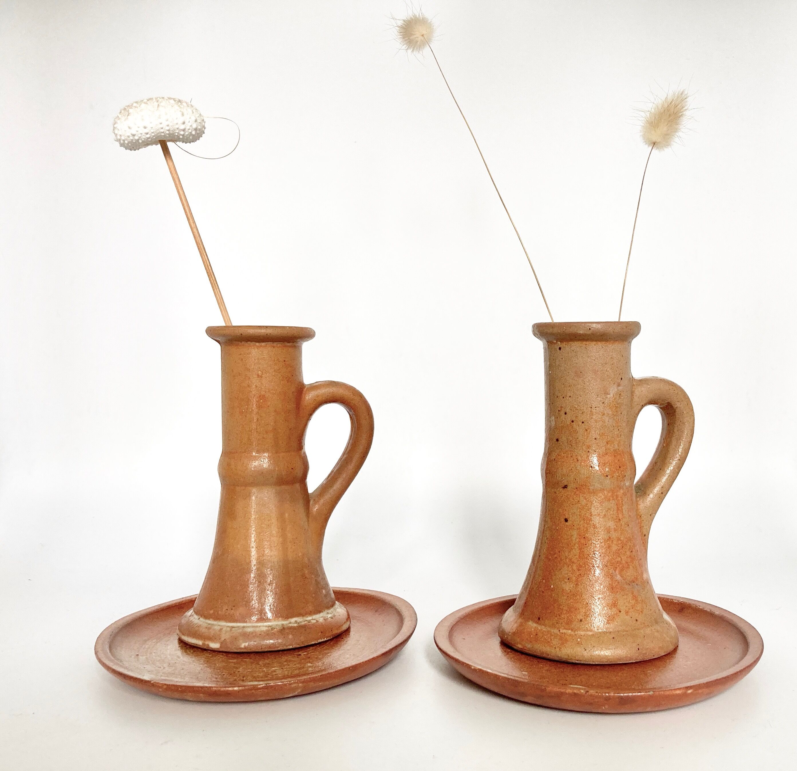 Pair of candlesticks and two sandstone cups