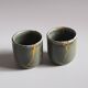 A pair of artisanal cups in traditional kintsugi.