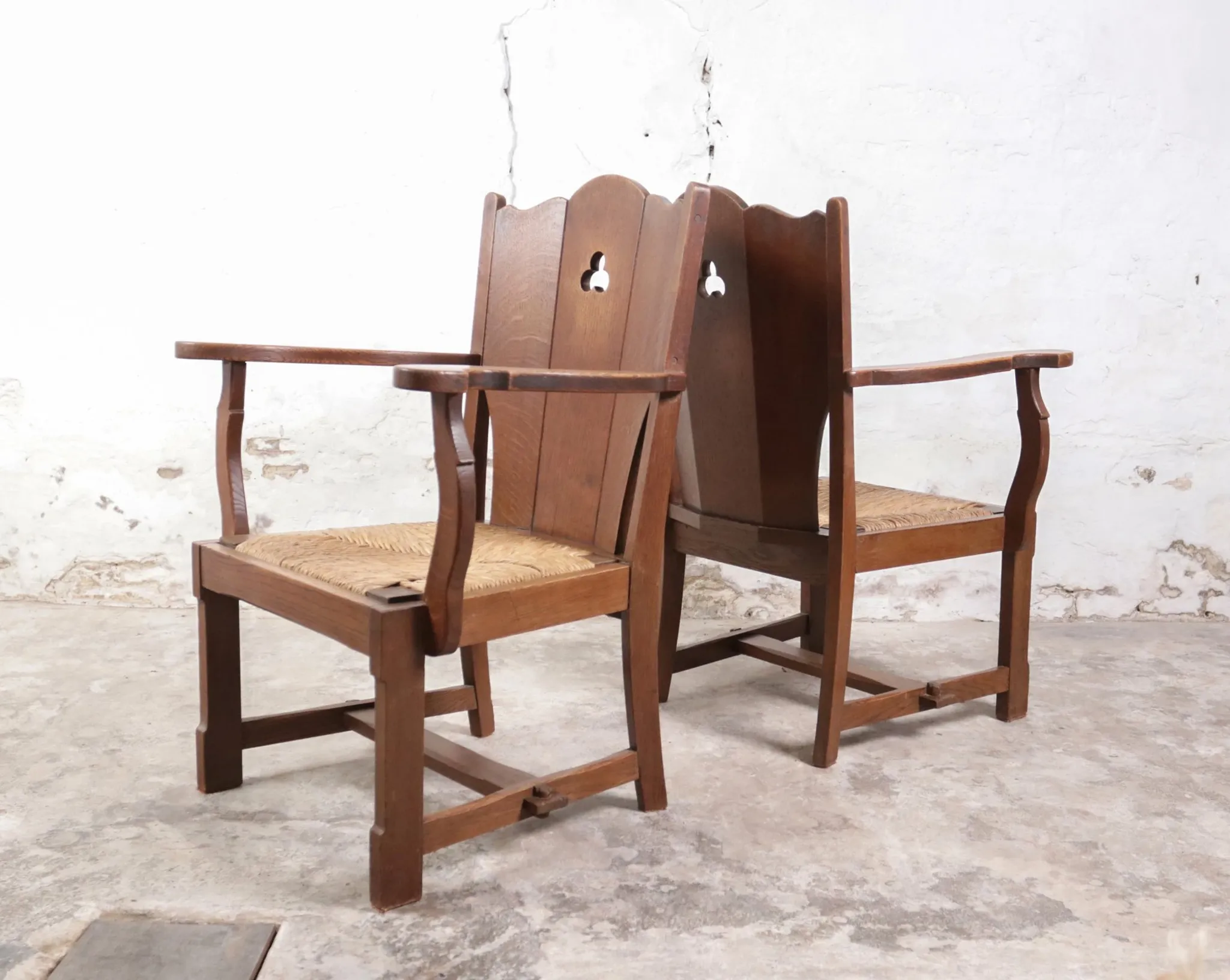 Pair of brutalist oak lounge chairs with rush seats – Netherlands