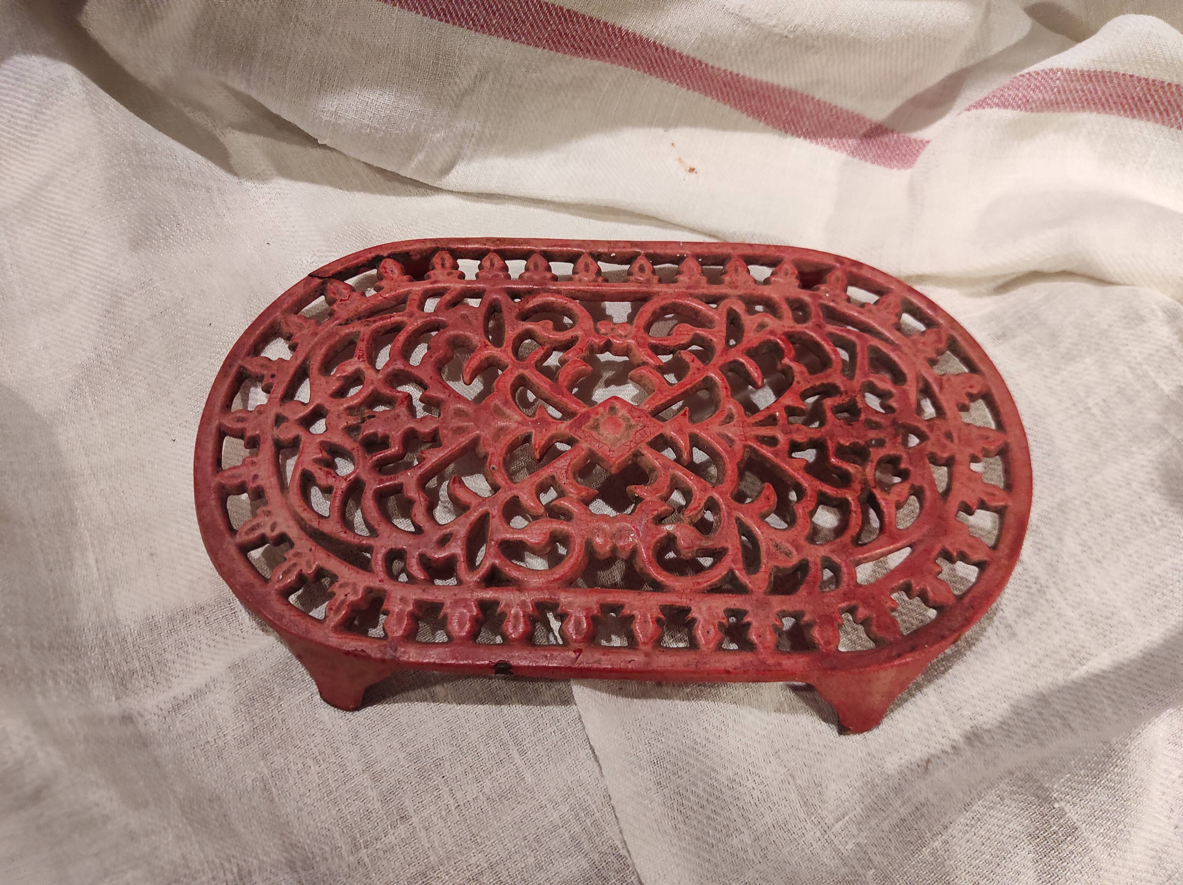 Vintage oval dark coral pink cast iron trivet
