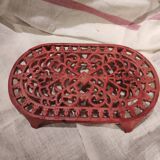 Vintage oval dark coral pink cast iron trivet