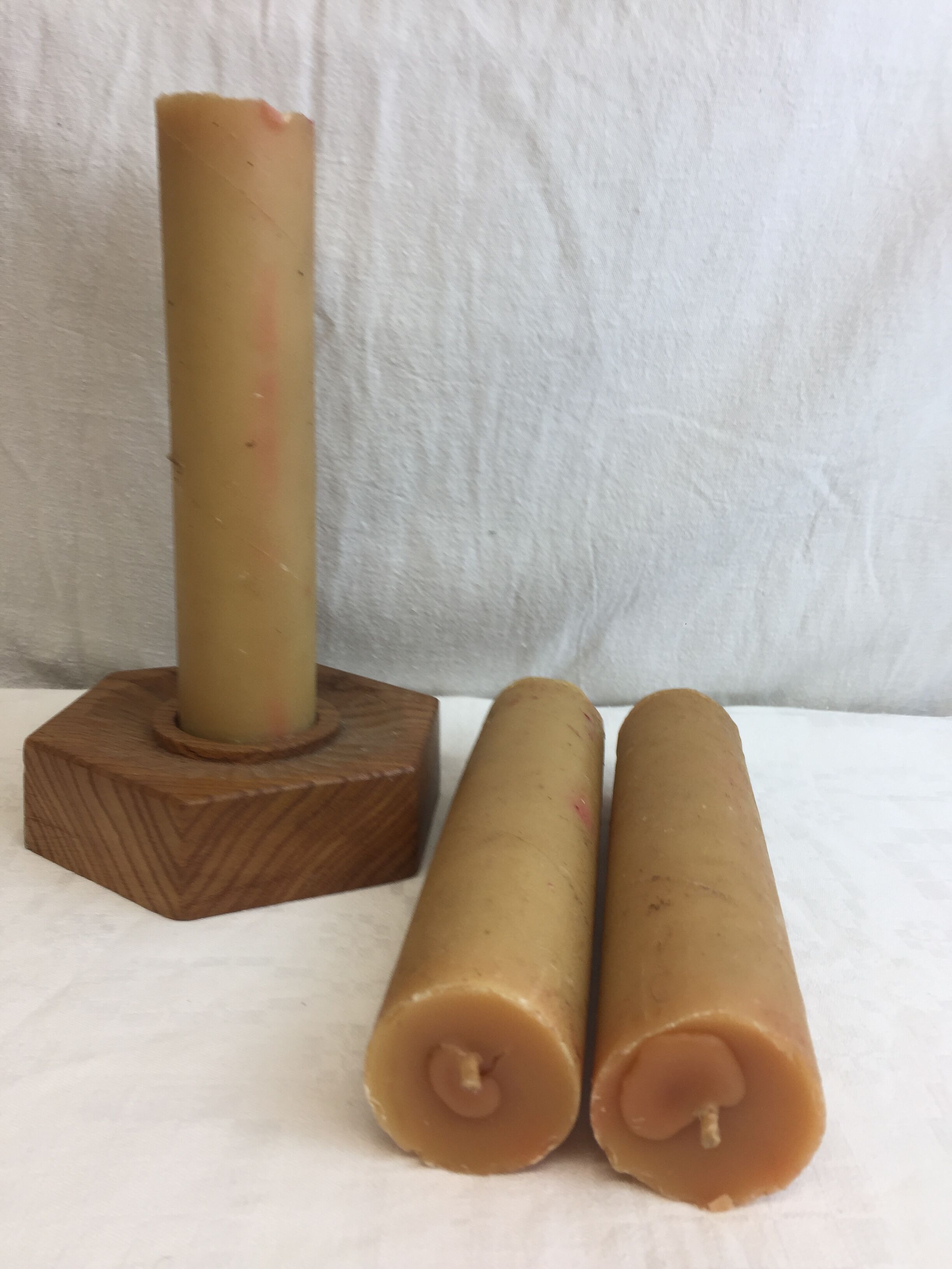 Handmade natural wood candle holder, hexagonal shape and its 3 old beeswax candles.