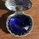 Vintage silver-plated shell butter dish with blue bowl.