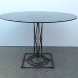 Wrought iron dining table with its round smoked glass top, vintage 1980