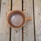 Brown sandstone cup with white spots