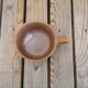 Brown sandstone cup with white spots
