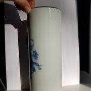 White porcelain vase from Limoges with blue decoration and gold rim.
