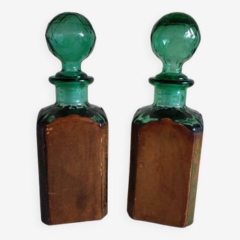 2 glass bottles with leather