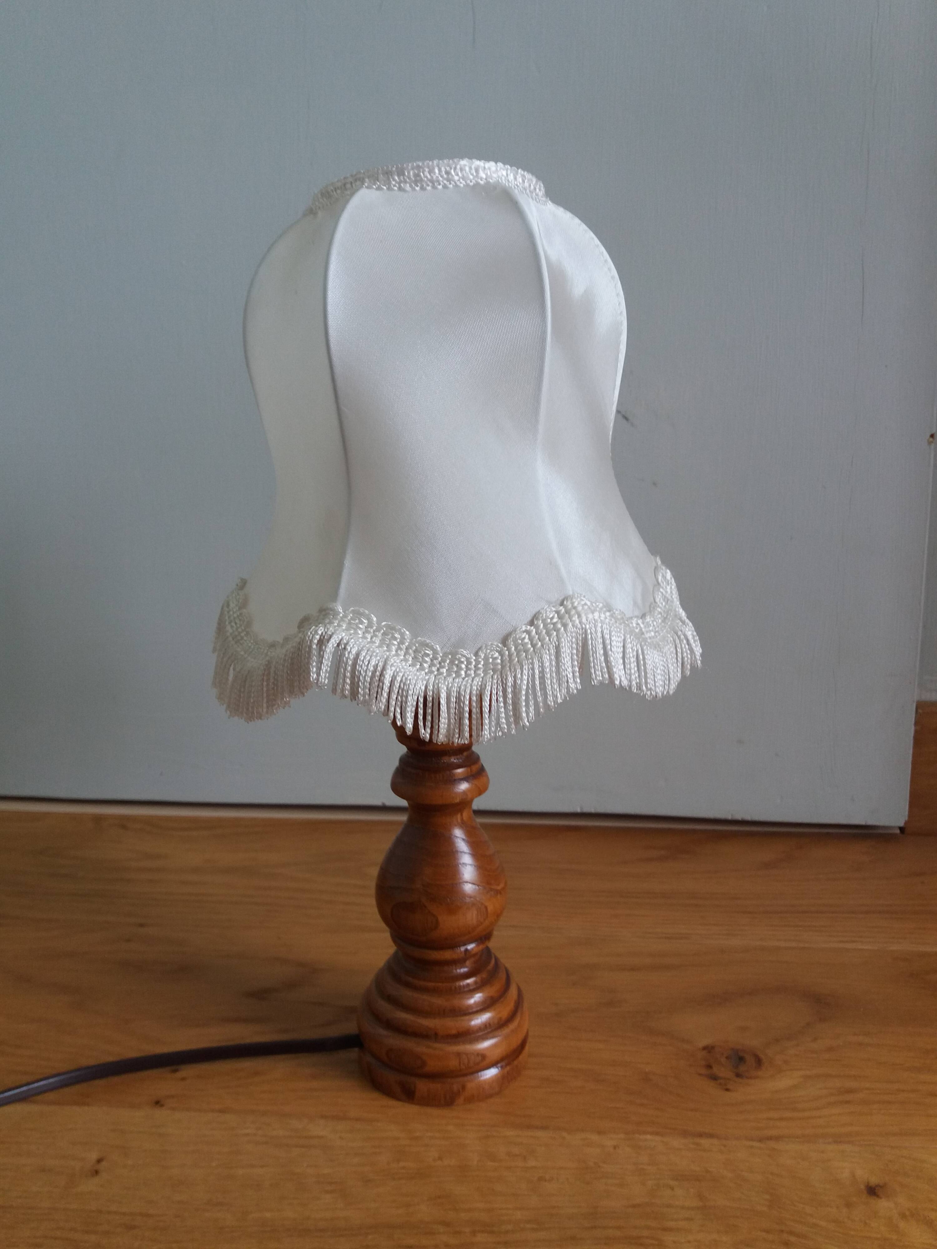 Turned wood lamp with fabric lampshade