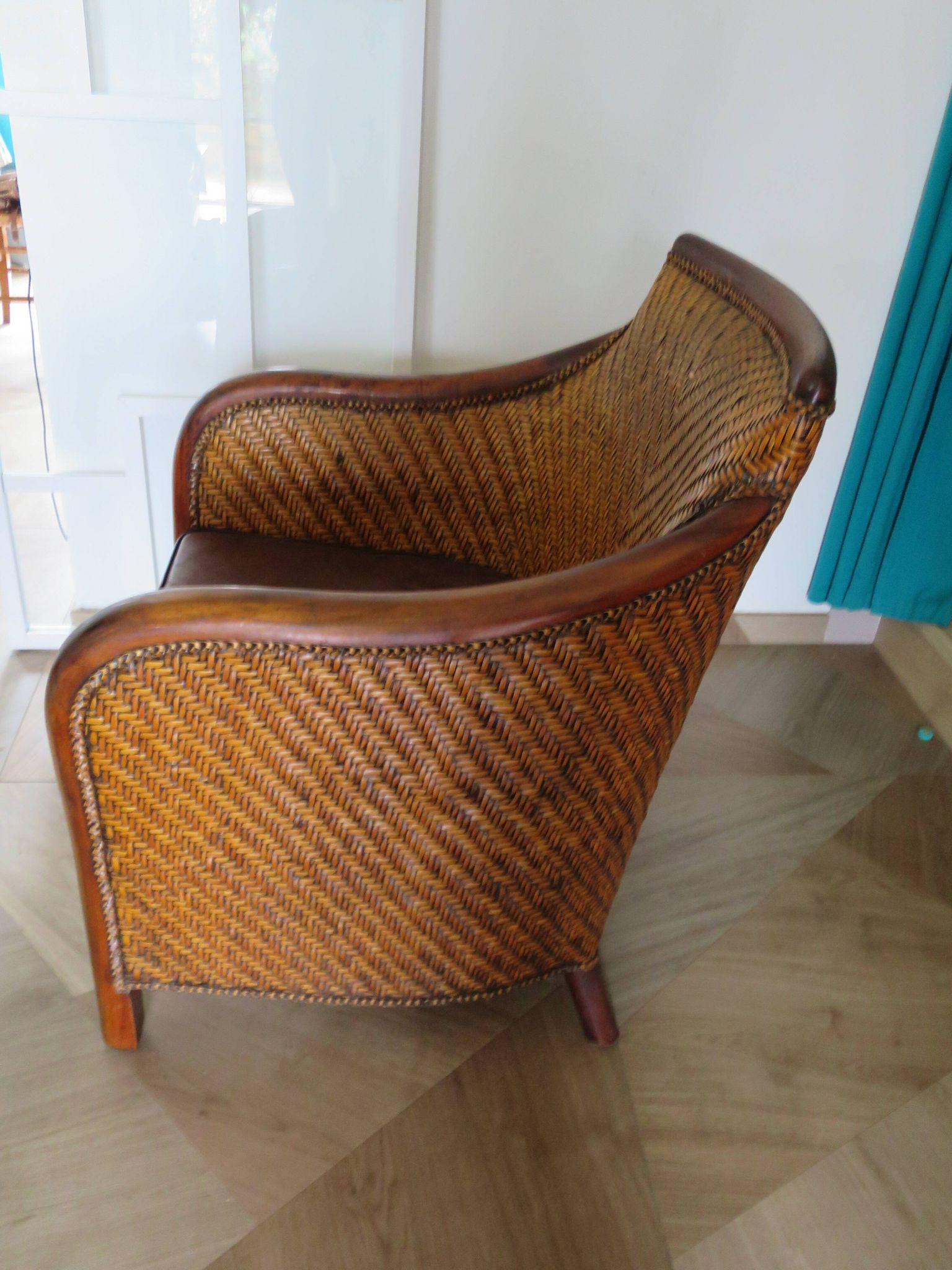 Woven rattan armchair and exotic wood in colonial style, 1980s.