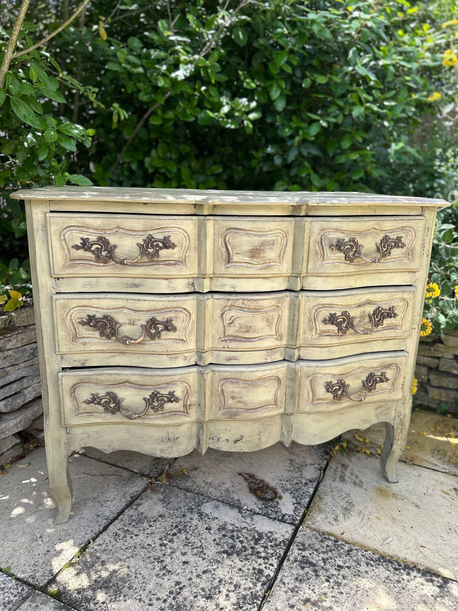 Curved antique commode in pistachio green patina.