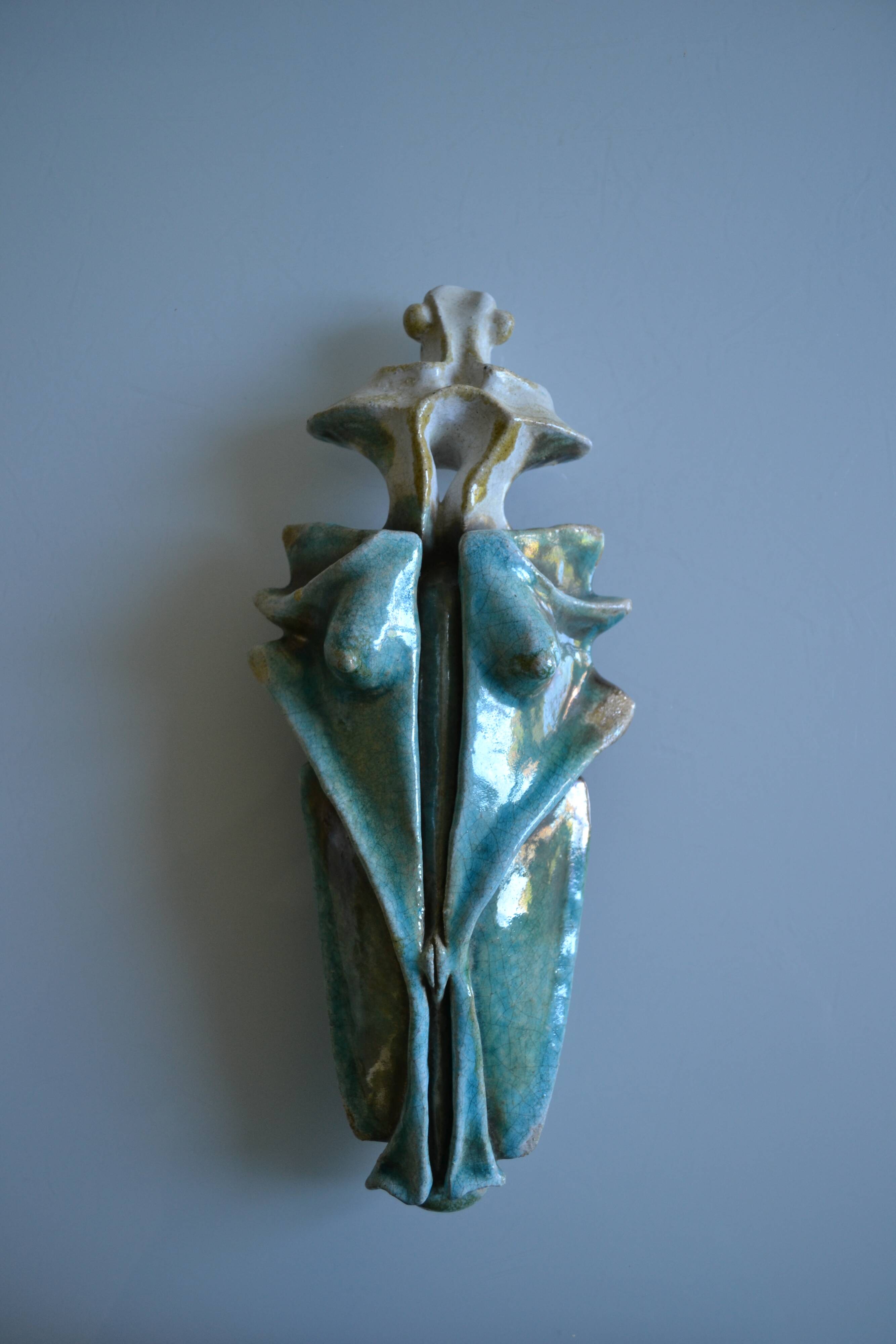 Surreal ceramic sculpture in relief signed to be identified.