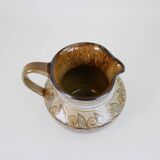 Glazed ceramic jug with plant decoration
