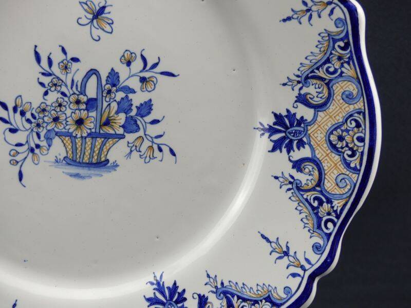 Old earthenware dish with a floral basket decoration.