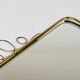 Wall mirror in brass wire with modernist loops from the mid-century, Italy, 1950s.