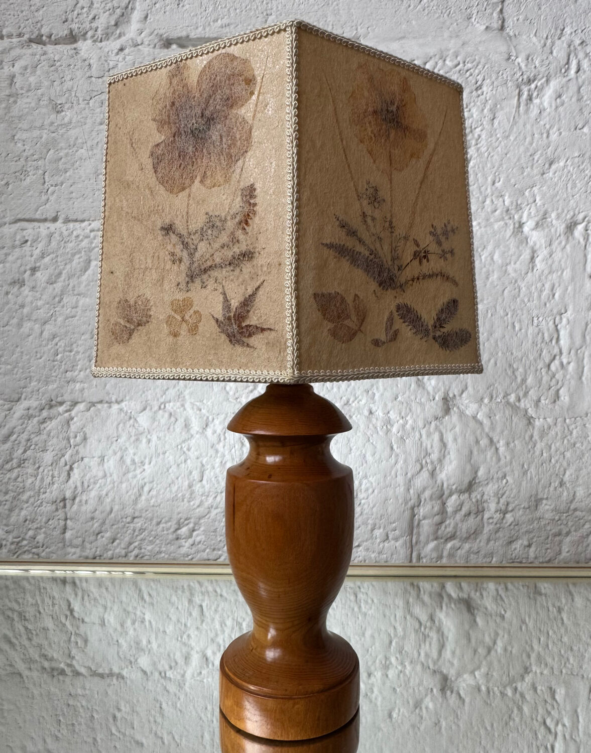 Turned wood lamp with a herbarium lampshade from the 1970s.