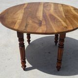 Round drop-leaf table made entirely of solid walnut