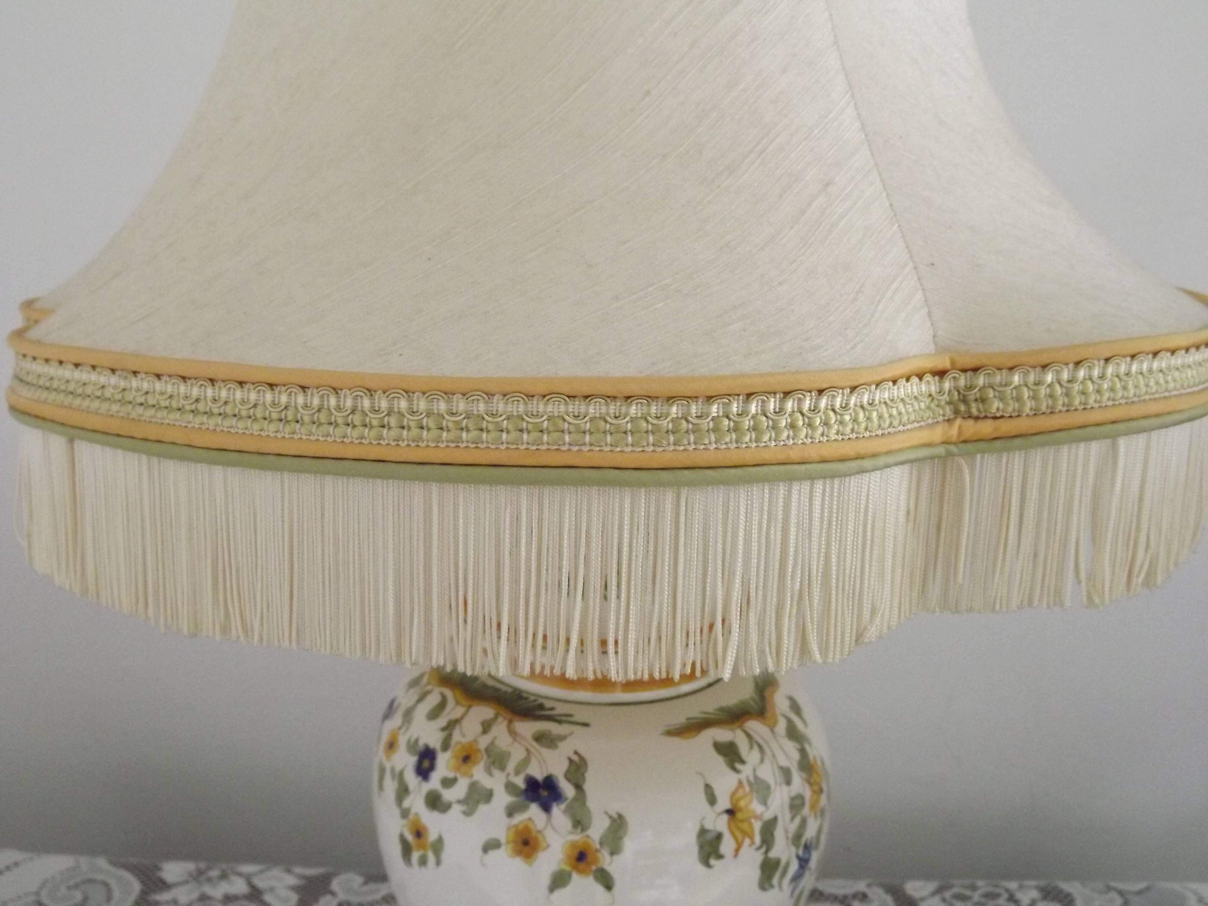 Table lamp with wooden base and fringed shade