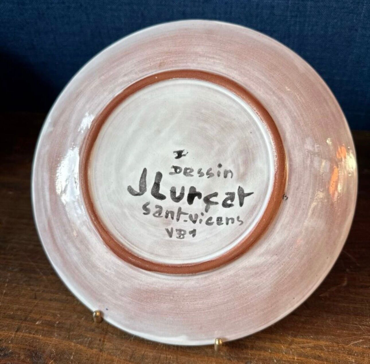 Terracotta plate, Jean Lurçat decorated with a character on a white background.